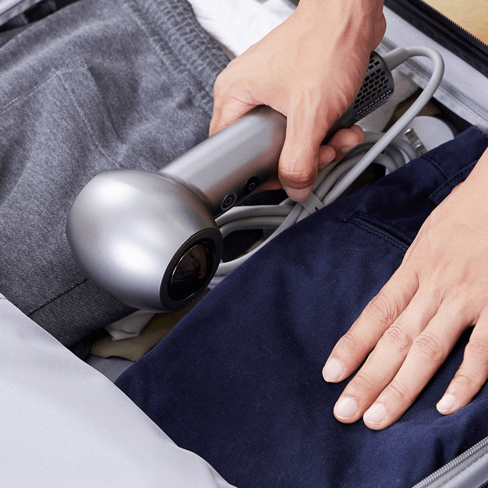SYLPH 2 hair dryer placed into a travel bag, packed for a trip