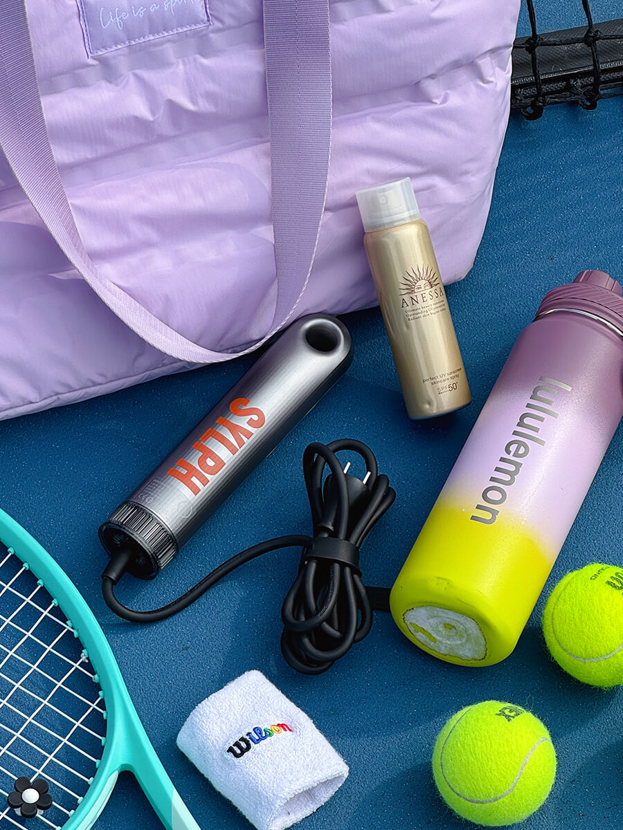 SYLPH 2 hair dryer flat lay with a dumbbell, balls and a purple gym bag